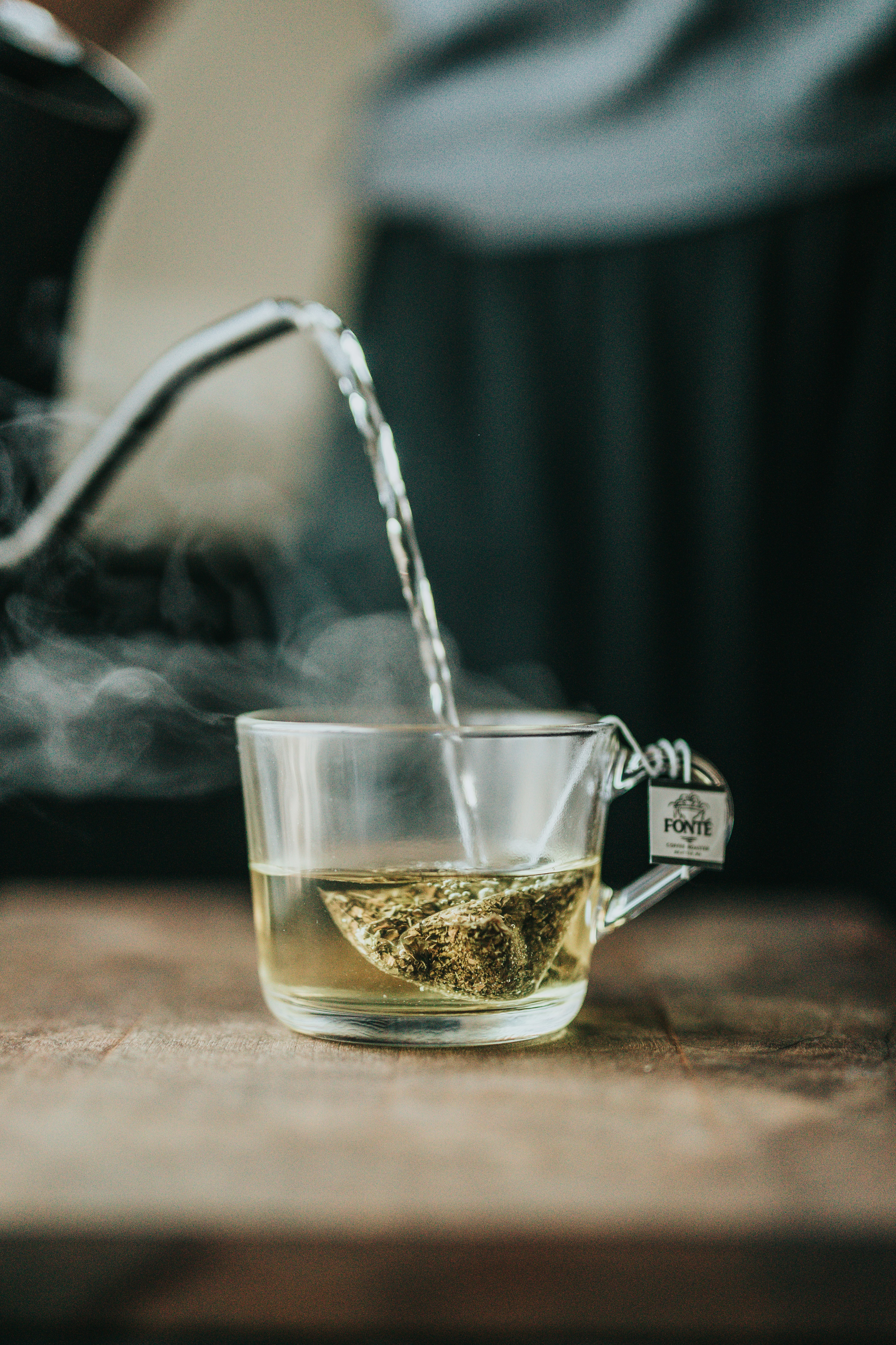 pouring clear glass teacup